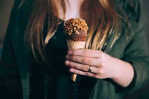 Woman holding ice cream and wearing silicone ring